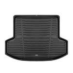 A set of black TuxMat trunk mats for Nissan Versa models.