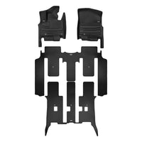 A set of black TuxMat car floor mats for Kia Carnival HEV models.