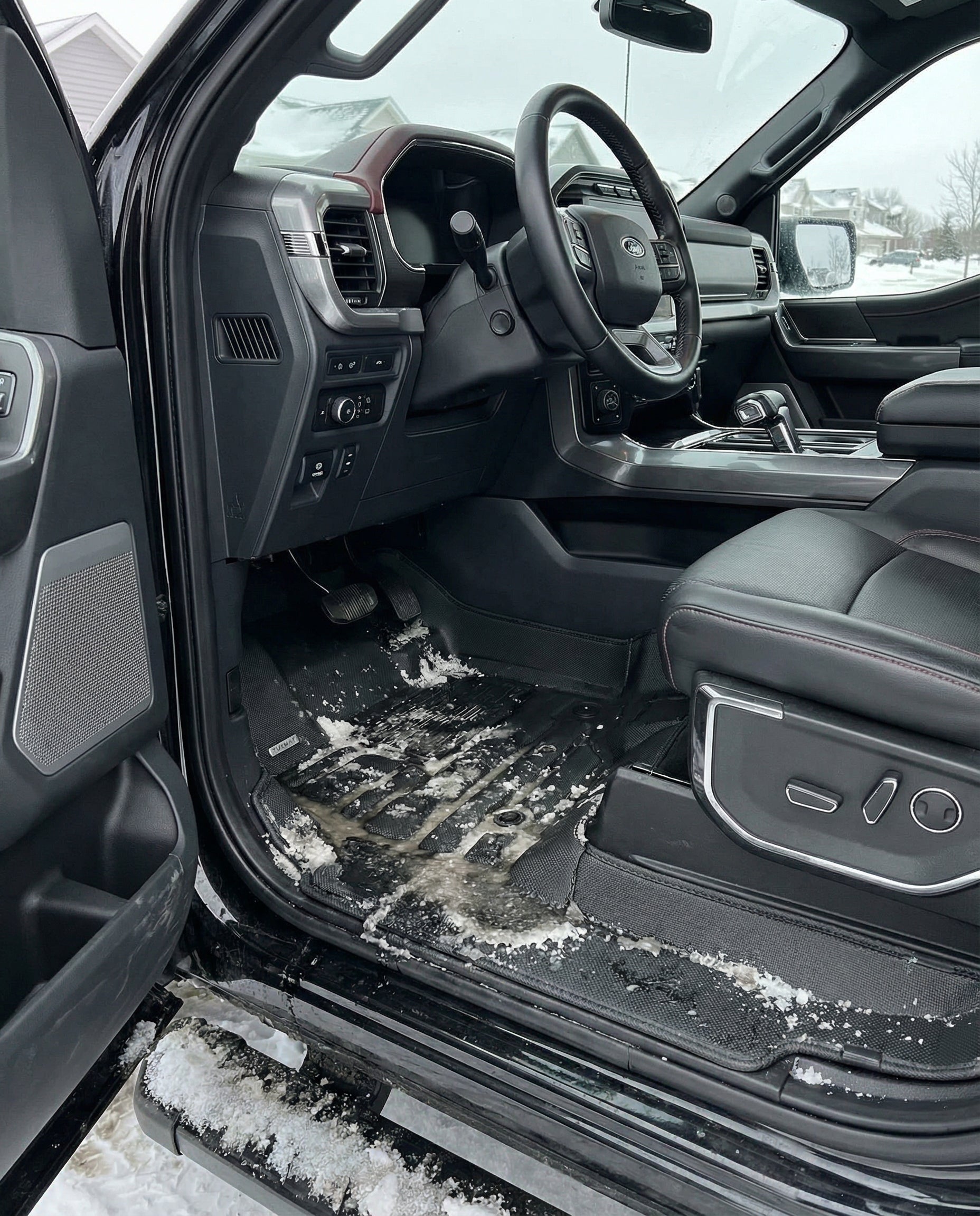 TuxMat floor liner in Ford F-150 with road slush and salt contained by raised edges